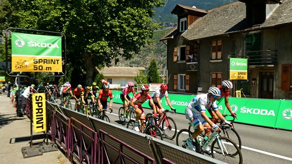 The peloton roll through the intermediate sprint in St Jean de Maurienne