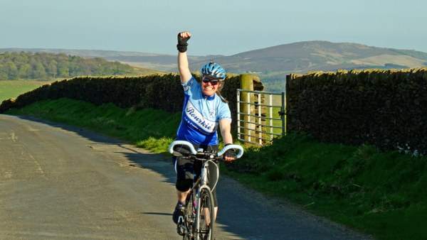 Helen raises her arm in triumph as we top out over the last climb of the day Helen raises her arm in triumph as we top out over the last climb of the day